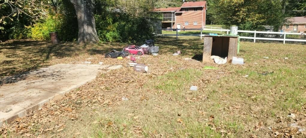 Backyard junk, old toys and a broken shed before cleanup